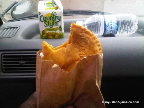 jamaican beef patty with drink- eating
