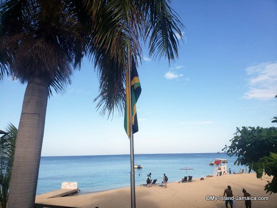 why_persons_visit_jamaica_flag_and_beach