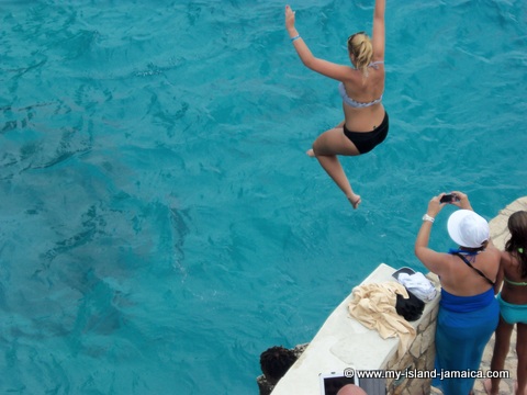 lady doing cliff jumping in negril