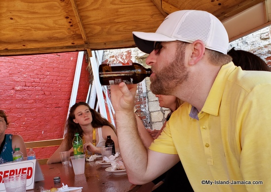 jamaican beer - visitor drinking jamaican beer