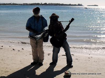 Jamaican men playing instruments on beach