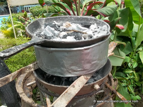 baking traditional potato pudding in Jamaica - hell a top, hell a bottom