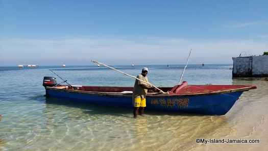 jamaican beach day - fishermen passing