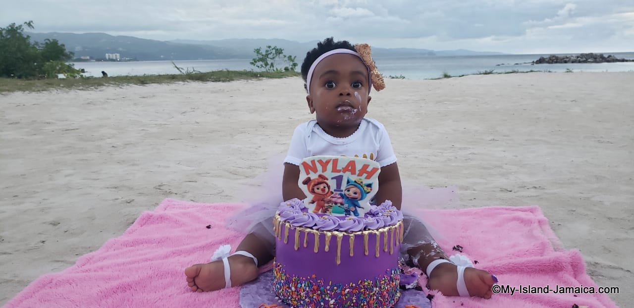 nylah_gayle_sitting_beside_cake_one_year