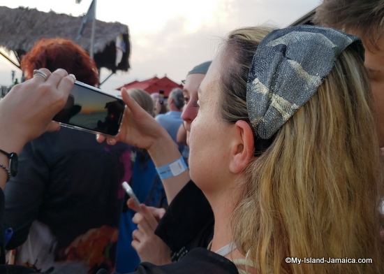 ricks_cafe_jamaica_guest_with_phone