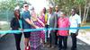 Photo shows.. USA couple Robert and Chelsea Pearson, cutting the ribbon to the newly paved roadway in Blacks Bay, Belmont Westmoreland, which they financed at the tune of over Jamaican $7,000,000 , the couple is seen here being flocked by Principal Of the Bluefields Basic School, Joy Baker (at left)  and Member of Parliament for Eastern Westmoreland, Luthur Buchanan, Council Valence Gifford and other members of the Bluefields Environmental and Protection Association (at right) .