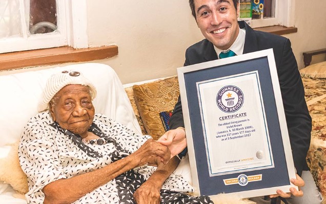 Jamaican Centenarian | Violet Brown Accepting Her Guinness World Record At Her Home From Carlos Martinez (Photo Credit: Guinness World Records) Jamaican Centenarian | Violet Brown Accepting Her Guinness World Record At Her Home From Carlos Martinez (Photo Credit: Guinness World Records)