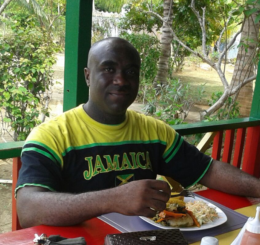 wellesley gayle eating jamaican food at little bay cabins